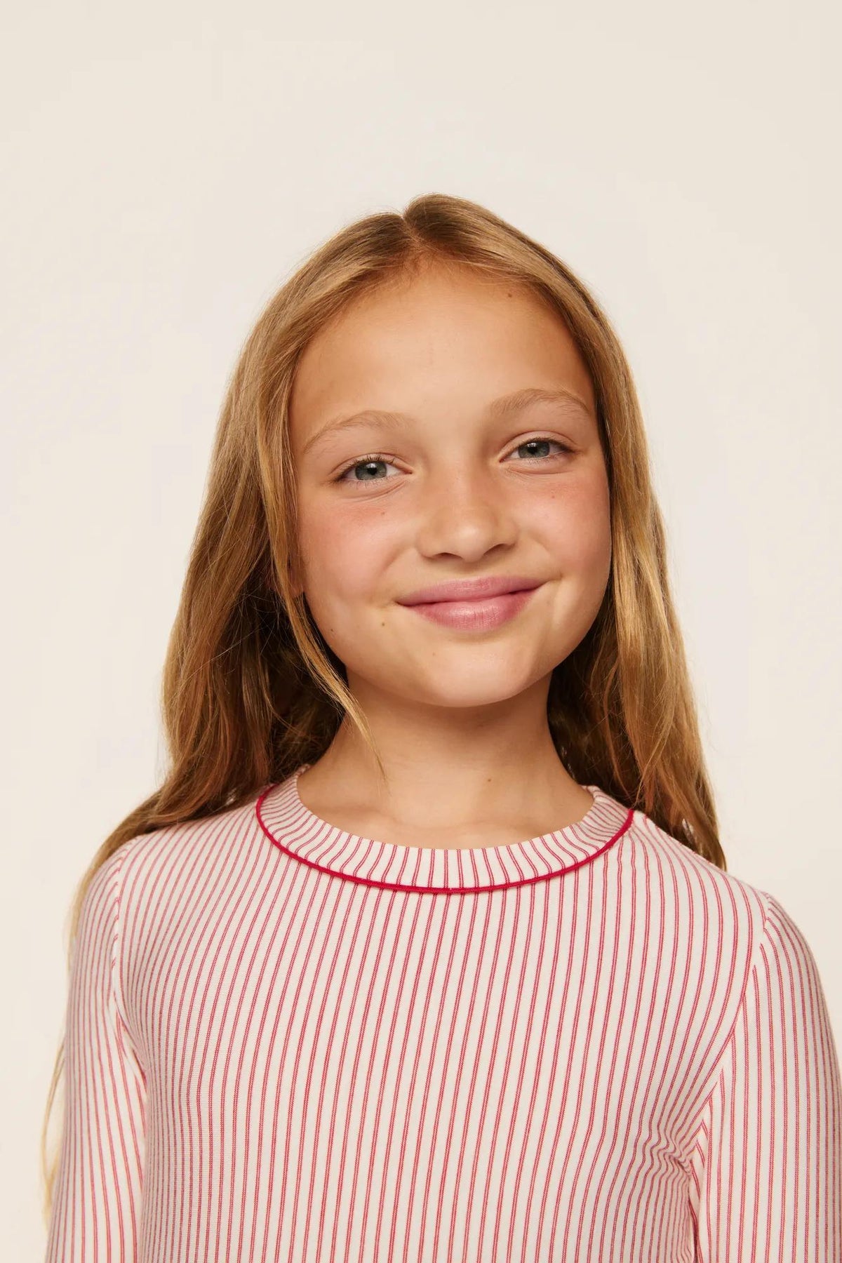 Model is wearing Kids Printed TENCEL™ Modal Unisex Long PJ Set in Duo Stripe Hollyred/Hollyred
