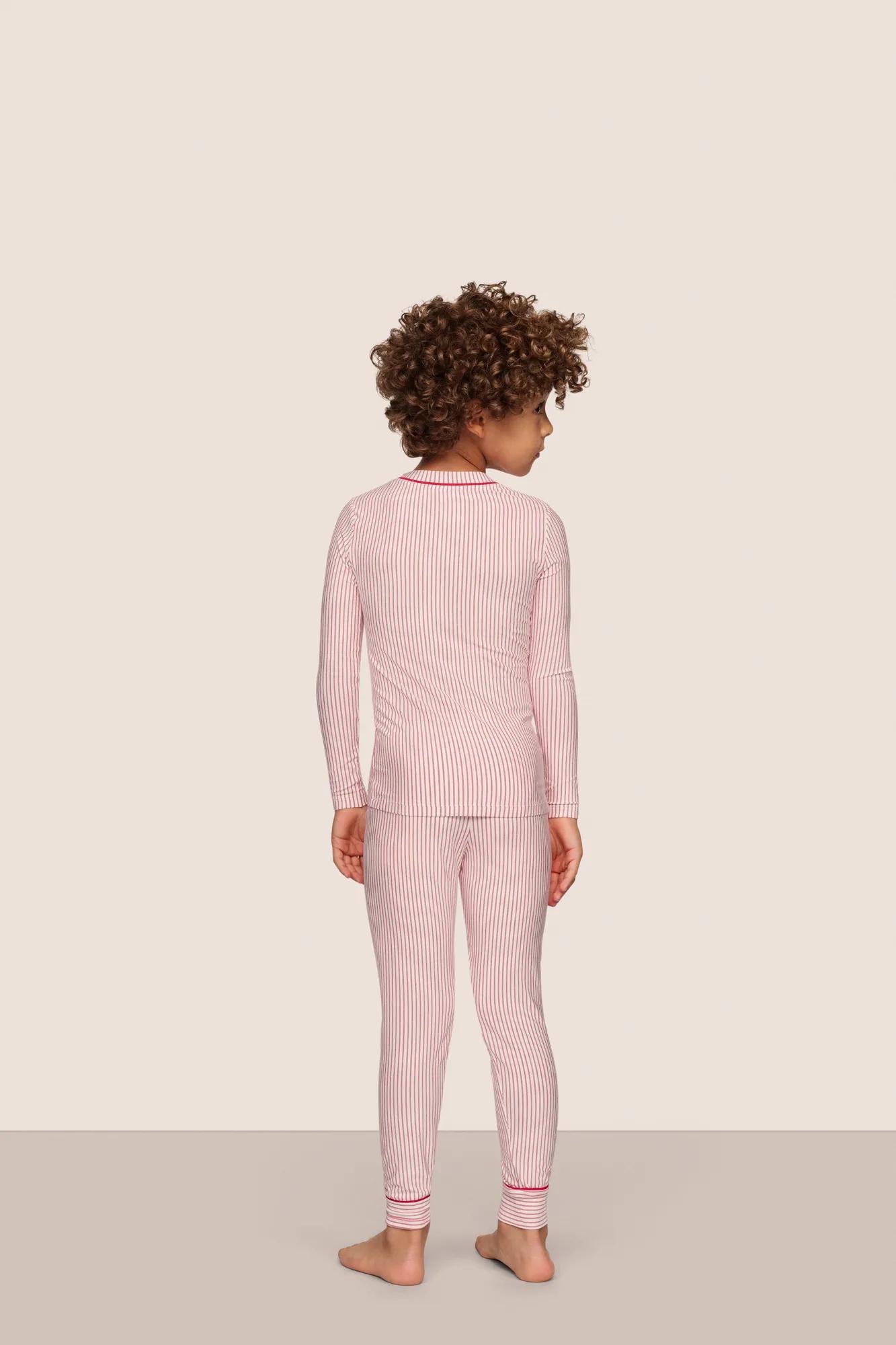 Model is wearing Kids Printed TENCEL™ Modal Unisex Long PJ Set  in Duo Stripe Hollyred/Hollyred