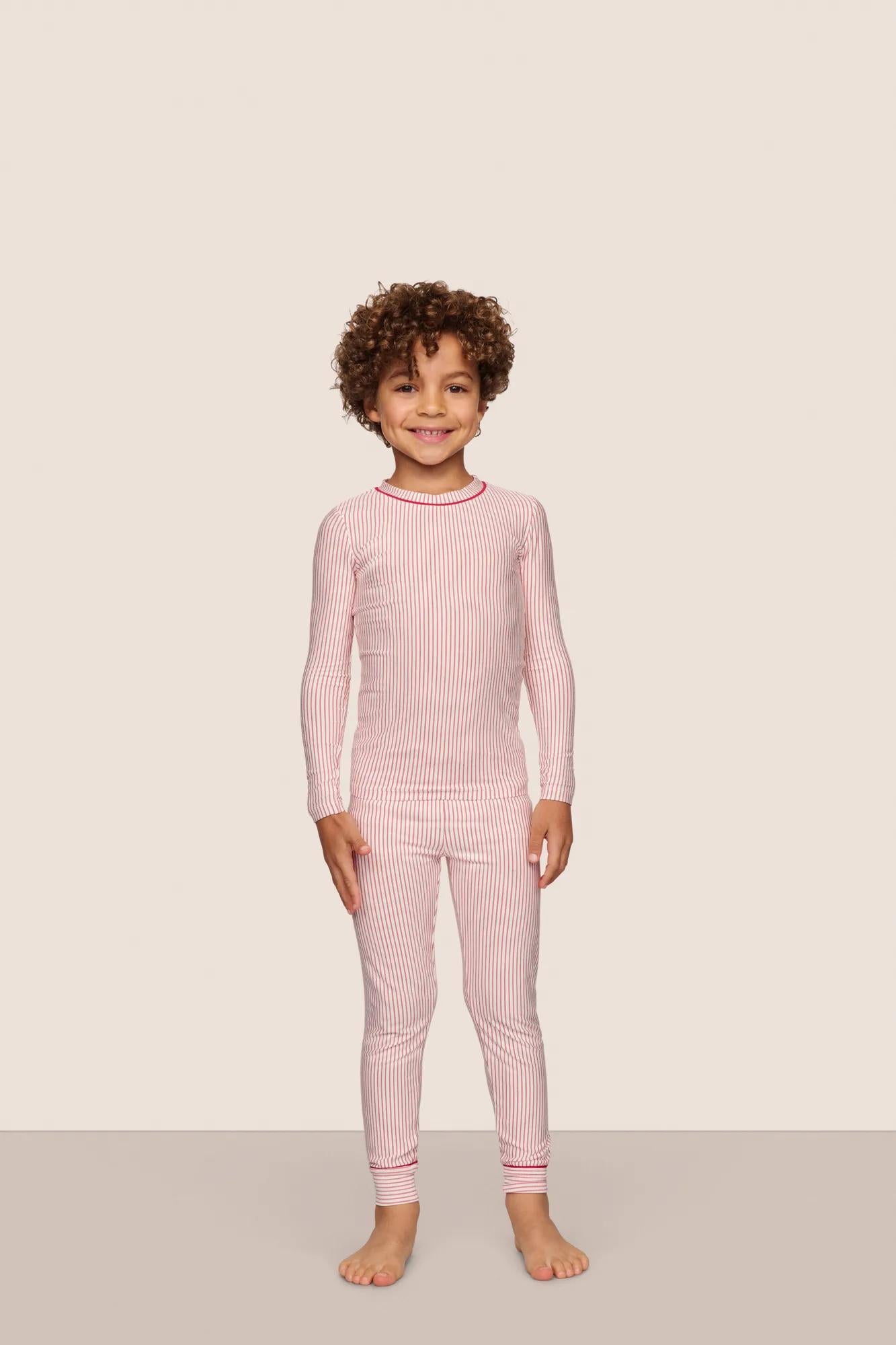 Model is wearing Kids Printed TENCEL™ Modal Unisex Long PJ Set  in Duo Stripe Hollyred/Hollyred