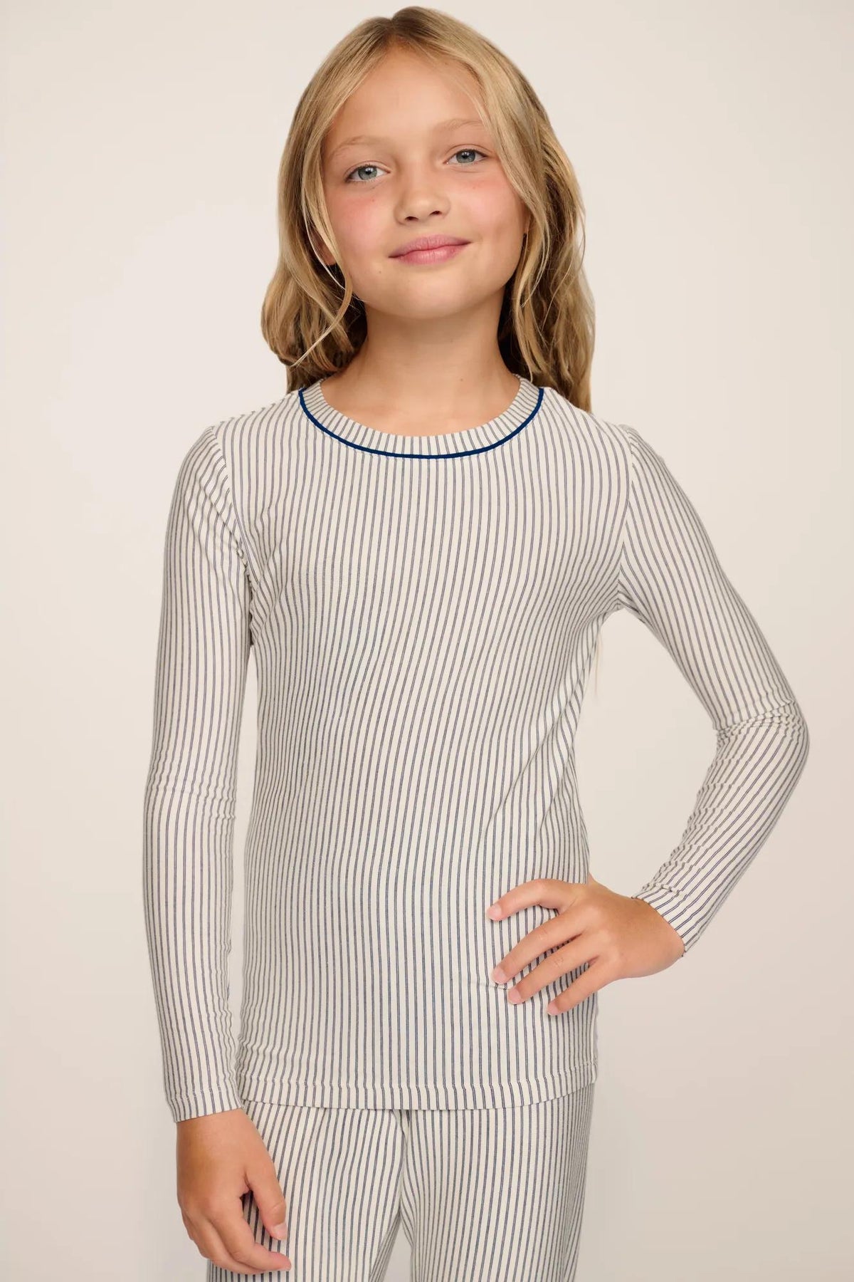 Model is wearing Kids Printed TENCEL™ Modal Unisex Long PJ Set in Duo Stripe Ivory/Navy
