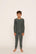Model is wearing Kids Printed TENCEL™ Modal Unisex Long PJ Set in Duo Stripe Pine/Ivory
