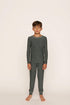 Model is wearing Kids Printed TENCEL™ Modal Unisex Long PJ Set in Duo Stripe Pine/Ivory