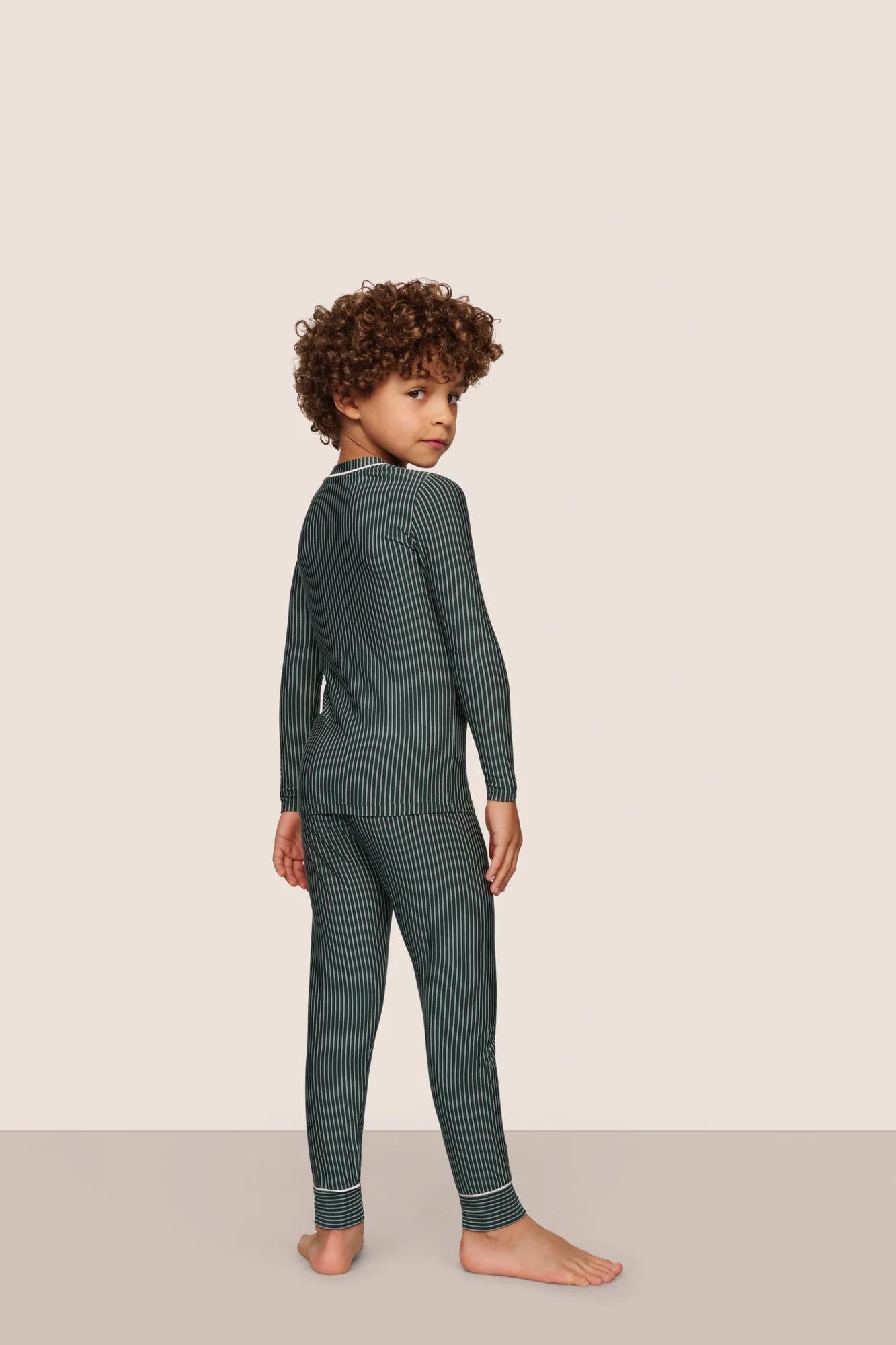 Model is wearing Kids Printed TENCEL™ Modal Unisex Long PJ Set  in Duo Stripe Pine/Ivory