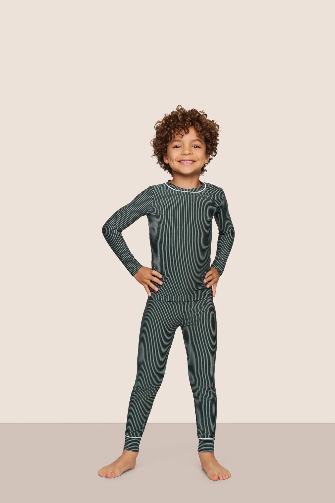 Model is wearing Kids Printed TENCEL™ Modal Unisex Long PJ Set  in Duo Stripe Pine/Ivory