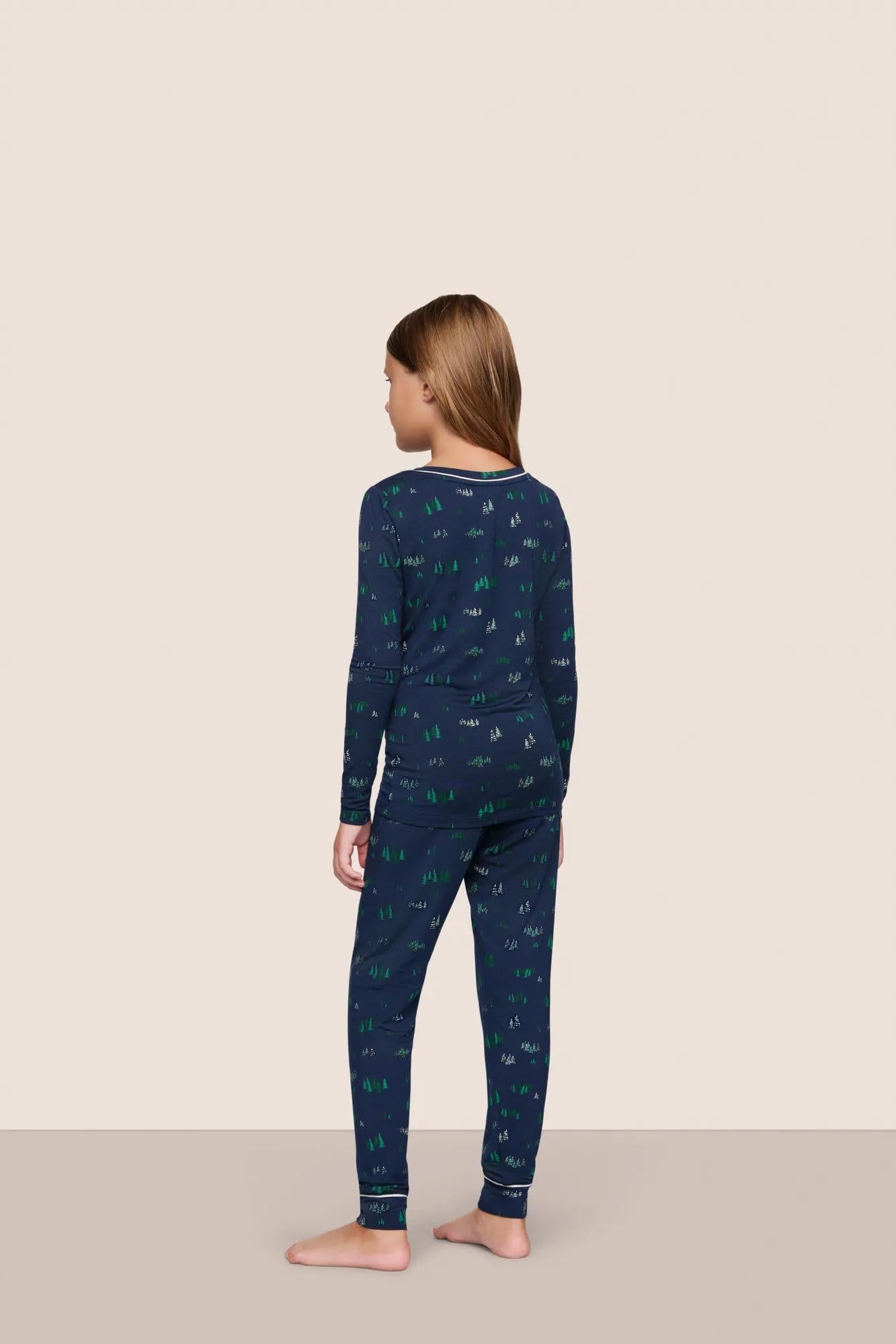 Model is wearing Kids Printed TENCEL™ Modal Unisex Long PJ Set  in Forest Pine Navy/Ivory