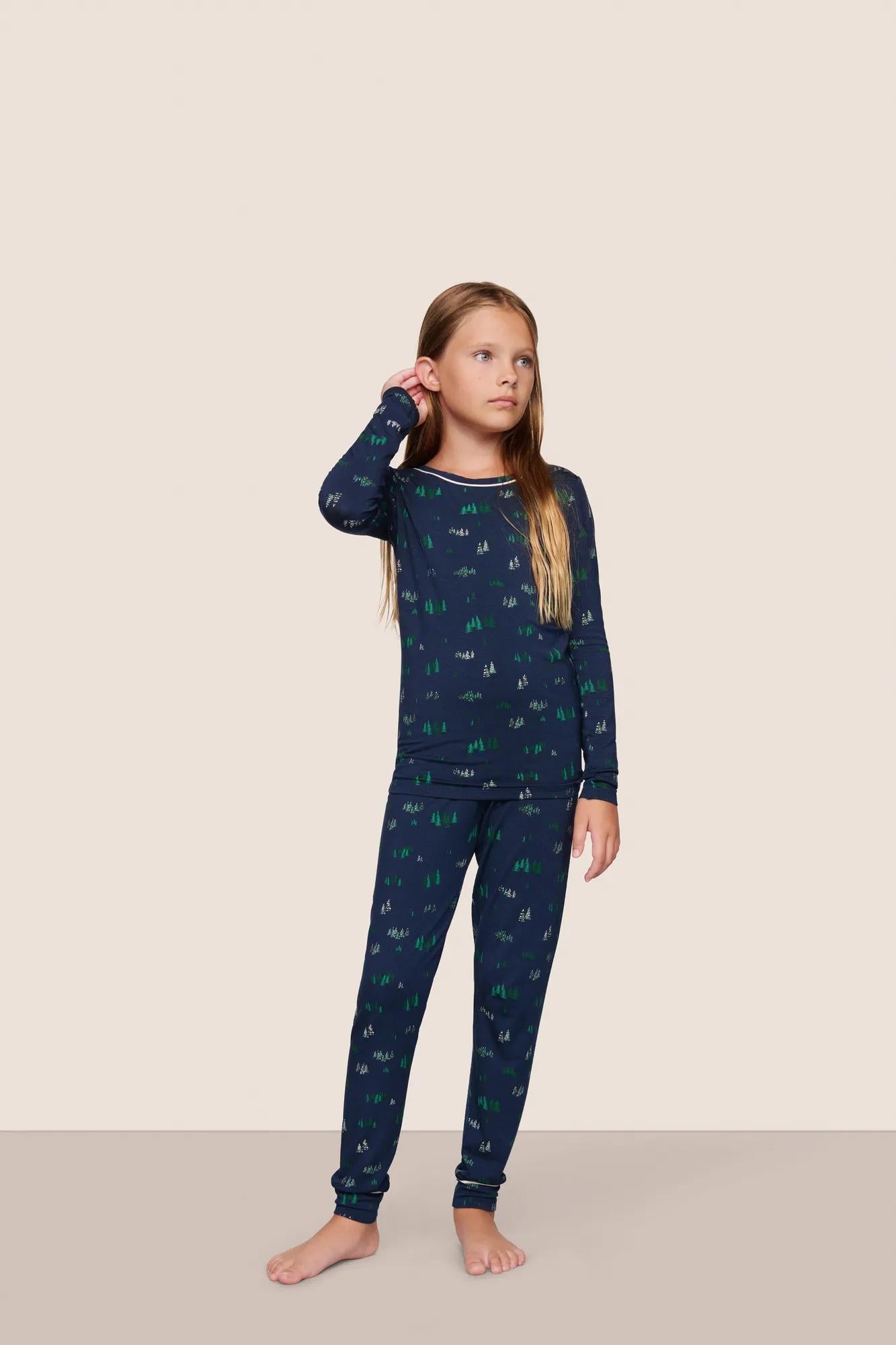 Model is wearing Kids Printed TENCEL™ Modal Unisex Long PJ Set  in Forest Pine Navy/Ivory