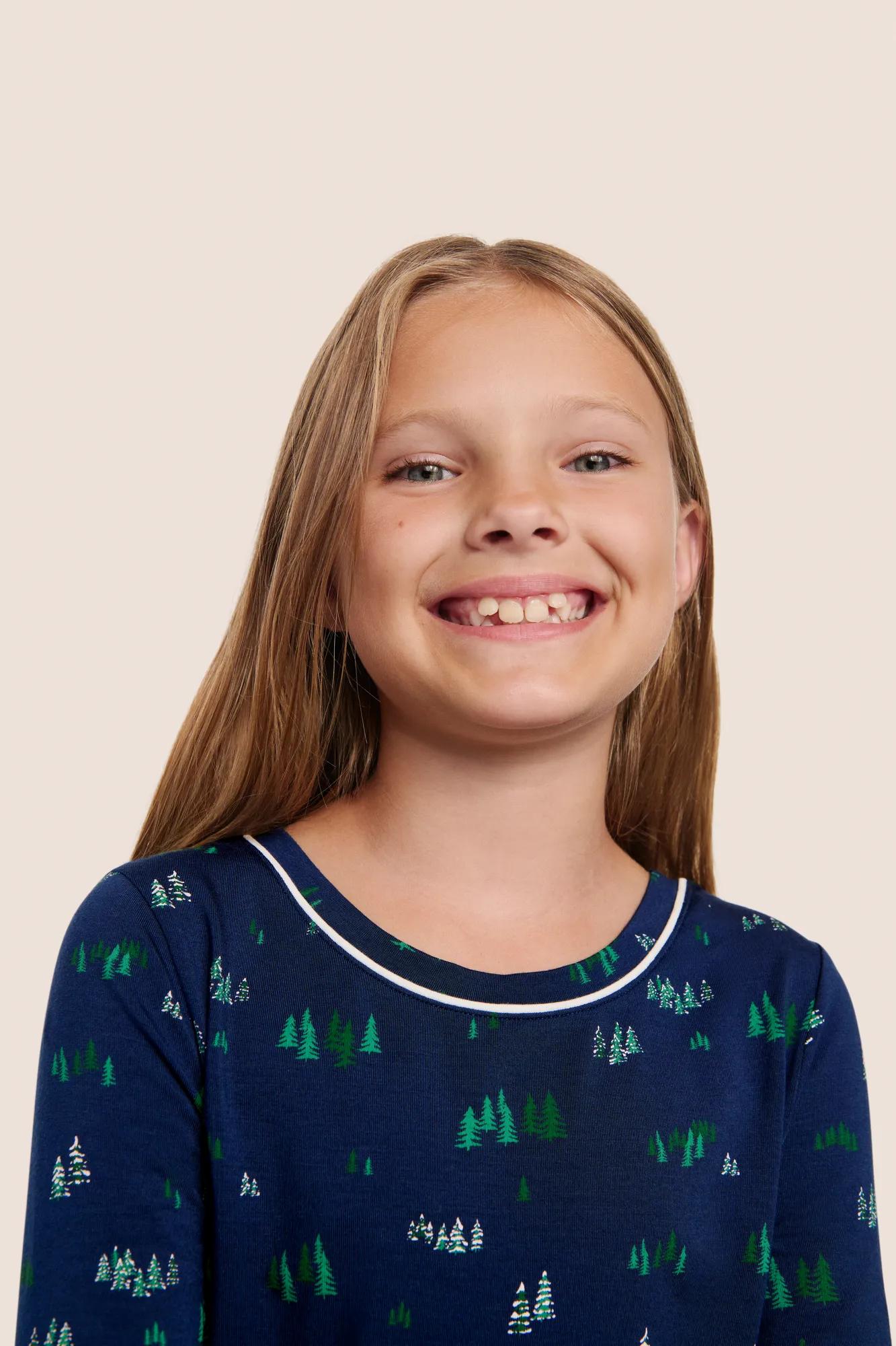 Model is wearing Kids Printed TENCEL™ Modal Unisex Long PJ Set  in Forest Pine Navy/Ivory