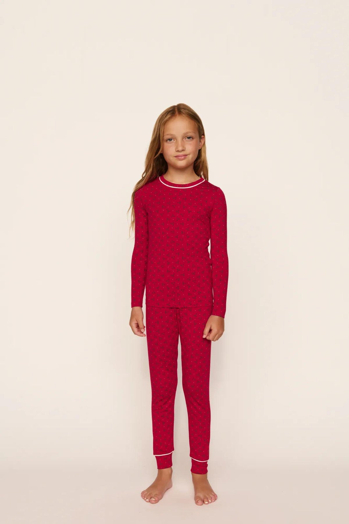 Model is wearing Kids Printed TENCEL™ Modal Unisex Long PJ Set in Hollyberry Holly Red/Ivory