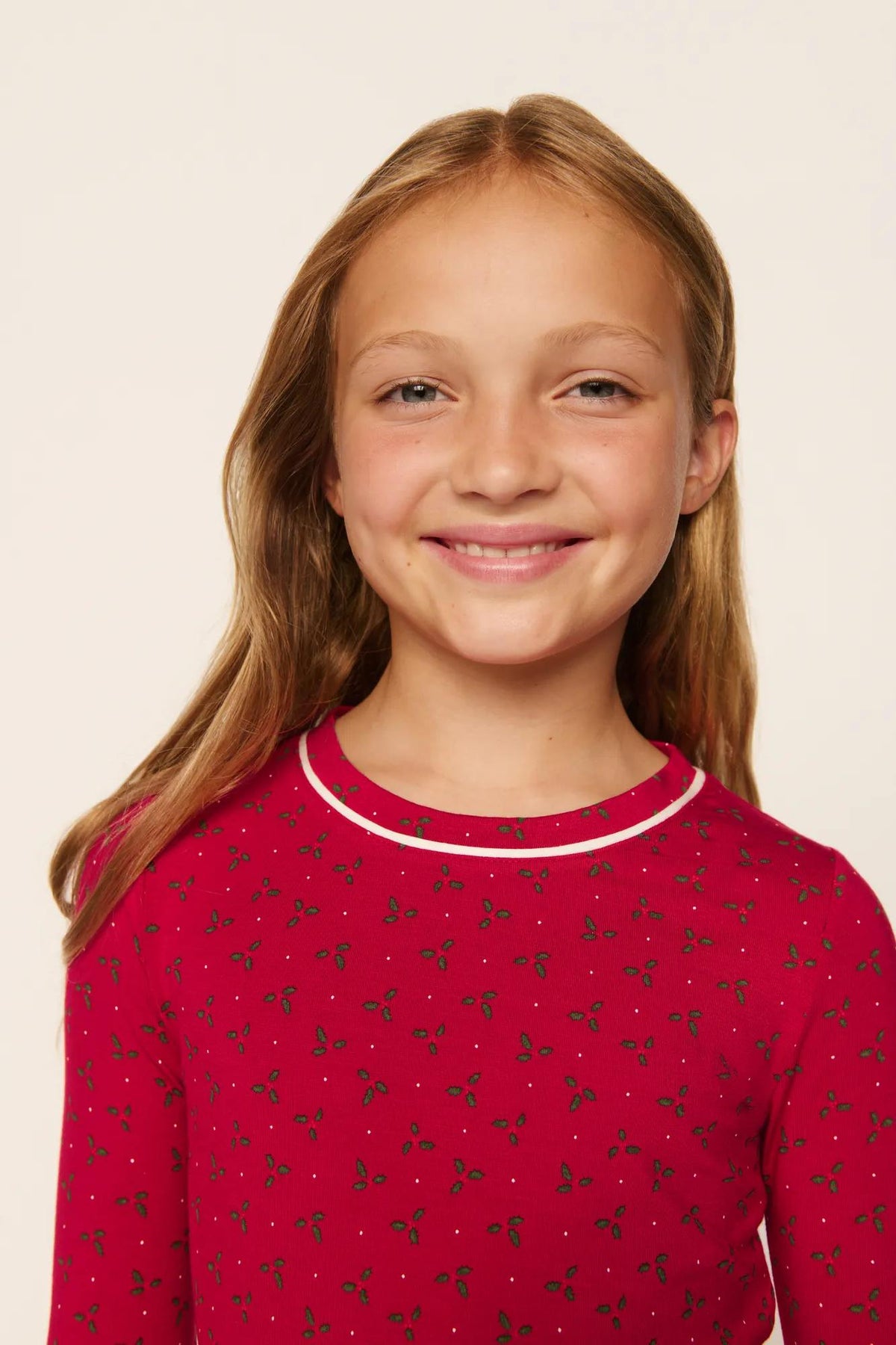 Model is wearing Kids Printed TENCEL™ Modal Unisex Long PJ Set in Hollyberry Holly Red/Ivory