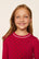 Model is wearing Kids Printed TENCEL™ Modal Unisex Long PJ Set in Hollyberry Holly Red/Ivory