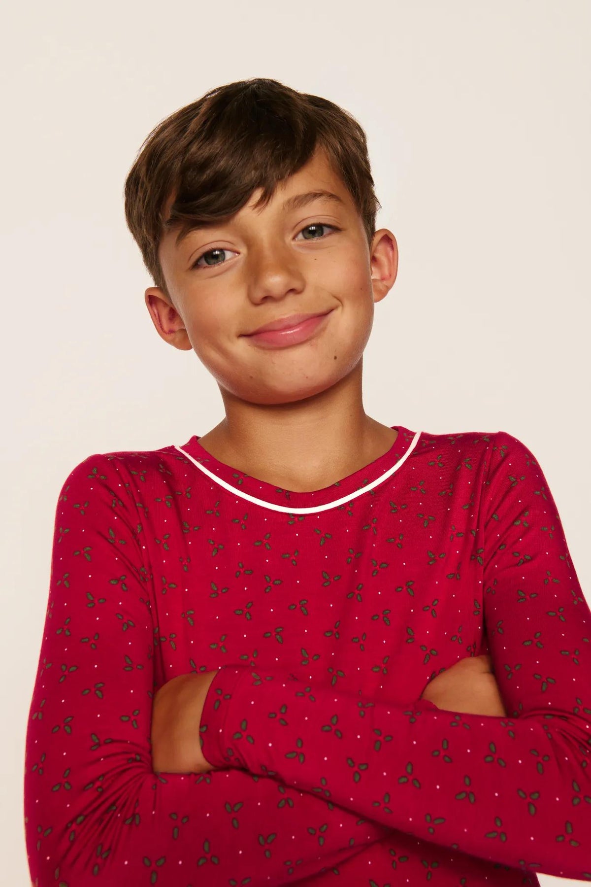 Model is wearing Kids Printed TENCEL™ Modal Unisex Long PJ Set in Hollyberry Holly Red/Ivory