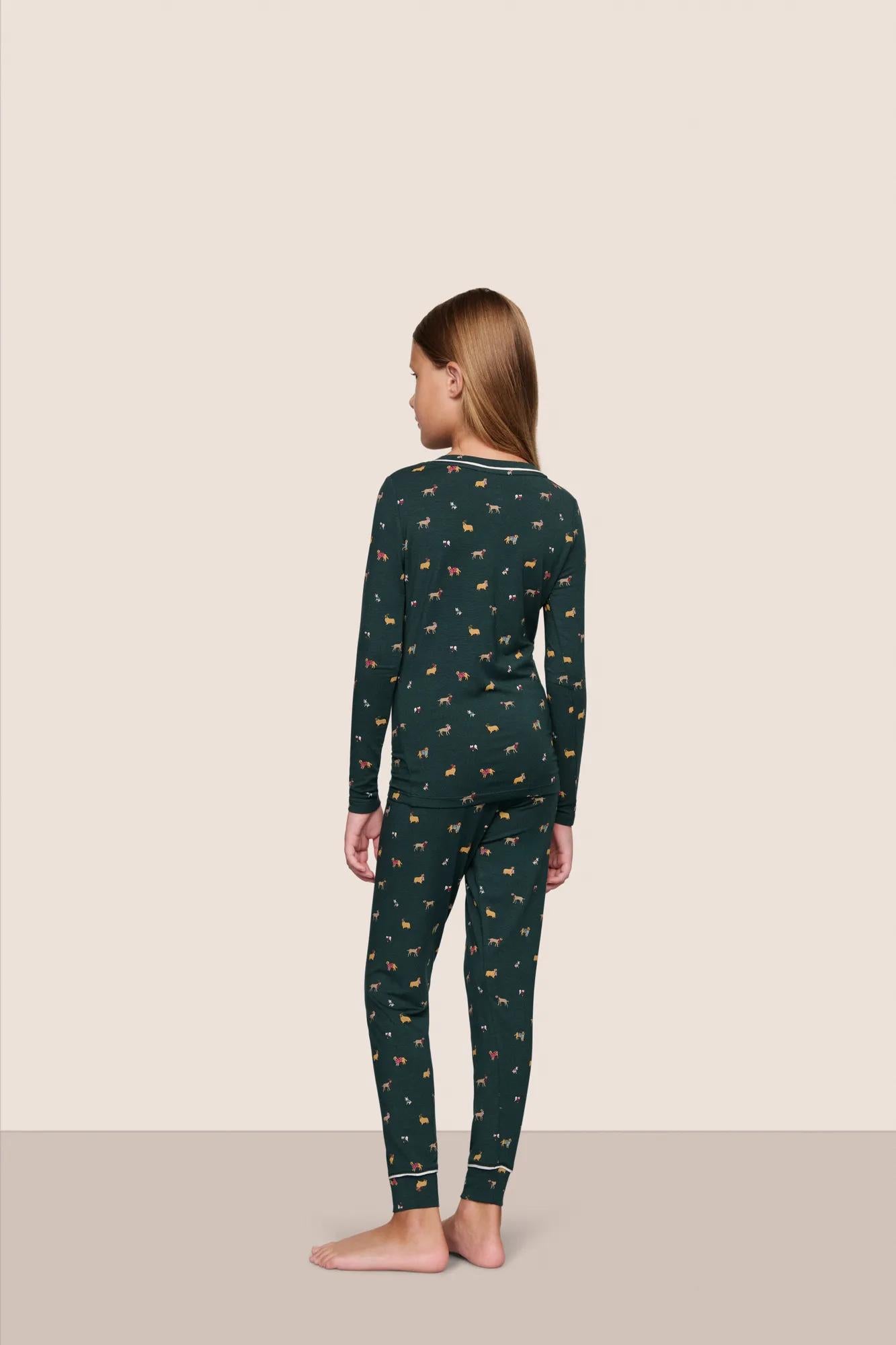 Model is wearing Kids Printed TENCEL™ Modal Unisex Long PJ Set  in Holiday Dogs Pine/Ivory