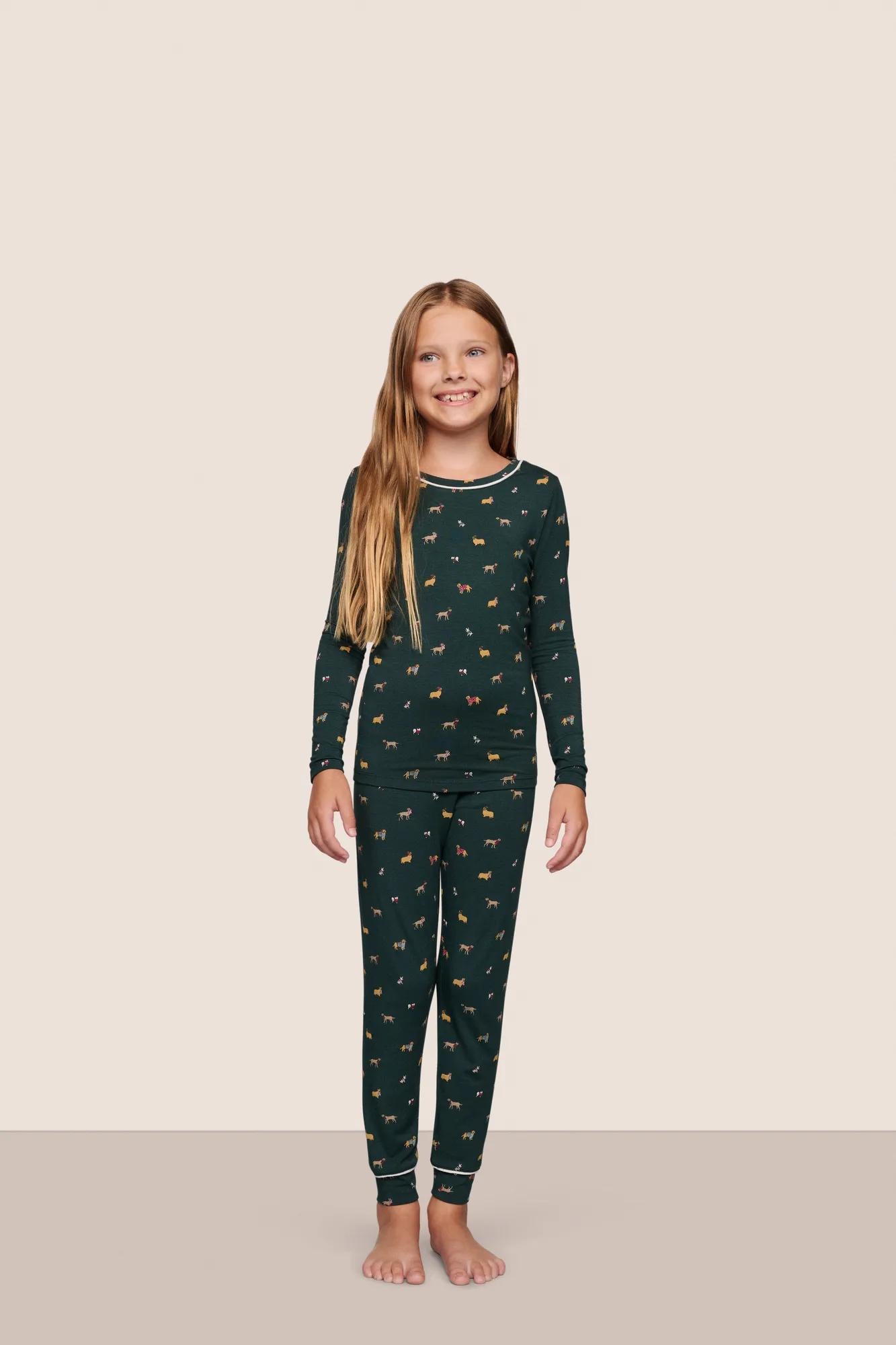 Model is wearing Kids Printed TENCEL™ Modal Unisex Long PJ Set  in Holiday Dogs Pine/Ivory