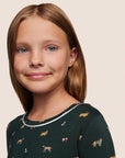 Model is wearing Kids Printed TENCEL™ Modal Unisex Long PJ Set  in Holiday Dogs Pine/Ivory