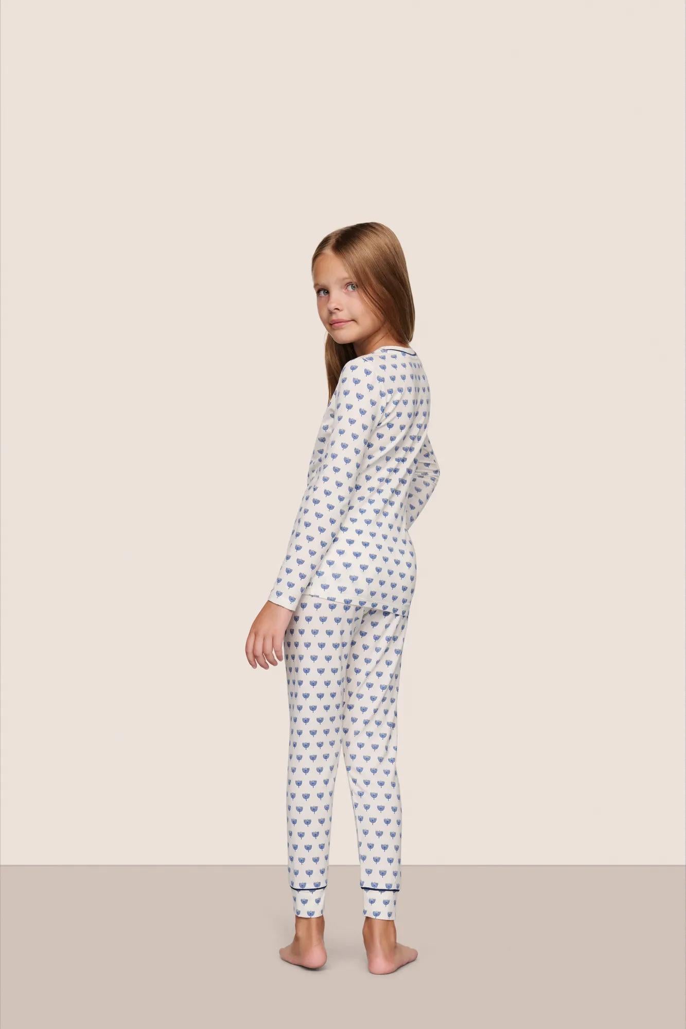 Model is wearing Kids Printed TENCEL™ Modal Unisex Long PJ Set  in Hannukah Glow Nouvean Navy/Ny