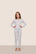 Model is wearing Kids Printed TENCEL™ Modal Unisex Long PJ Set  in Hannukah Glow Nouvean Navy/Ny