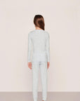Model is wearing Kids Printed TENCEL™ Modal Unisex Long PJ Set in Large Swans Ice Blue/Ivory