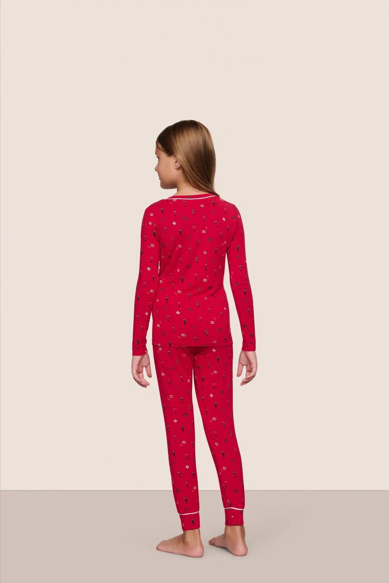 Model is wearing Kids Printed TENCEL™ Modal Unisex Long PJ Set  in Nutcracker Holly Red/Ivory