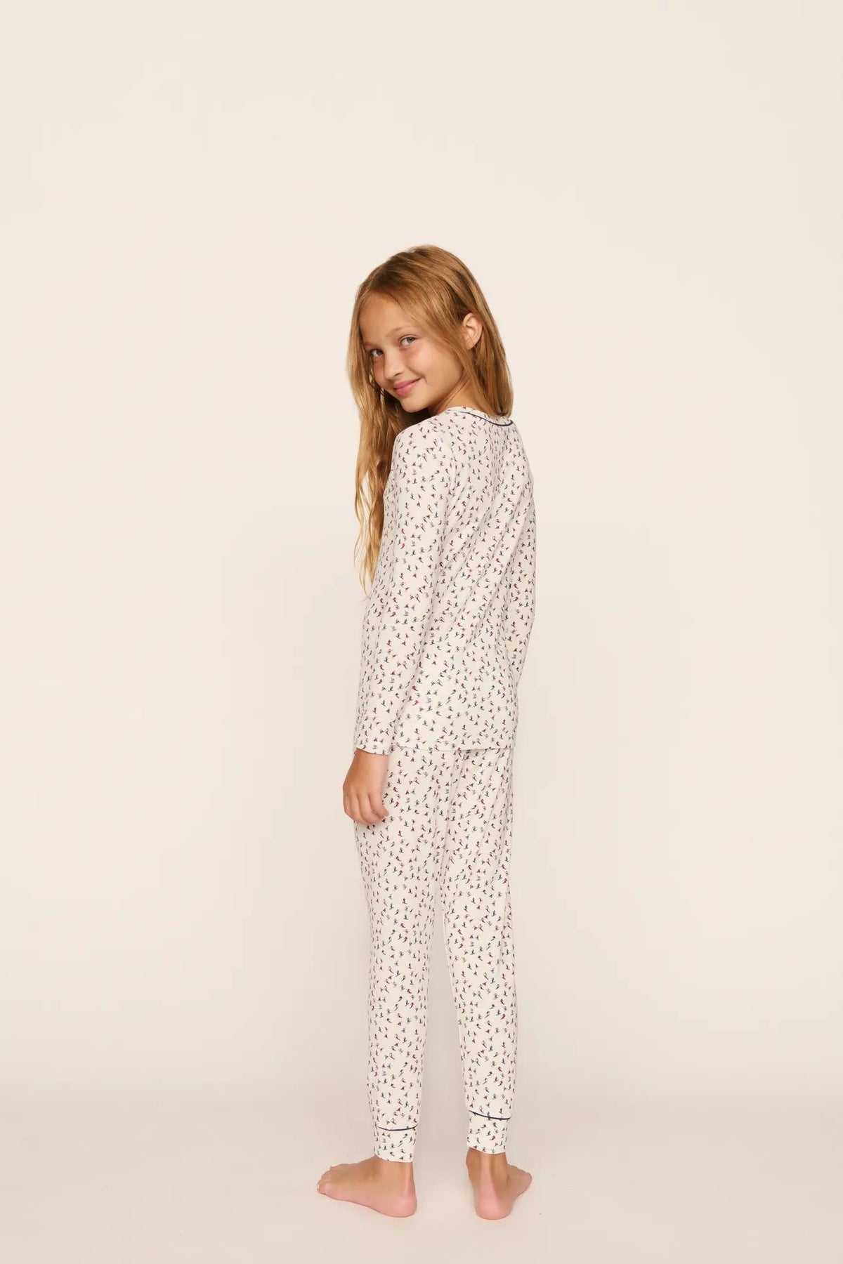 Model is wearing Kids Printed TENCEL™ Modal Unisex Long PJ Set in On The Slopes Ivory/Navy
