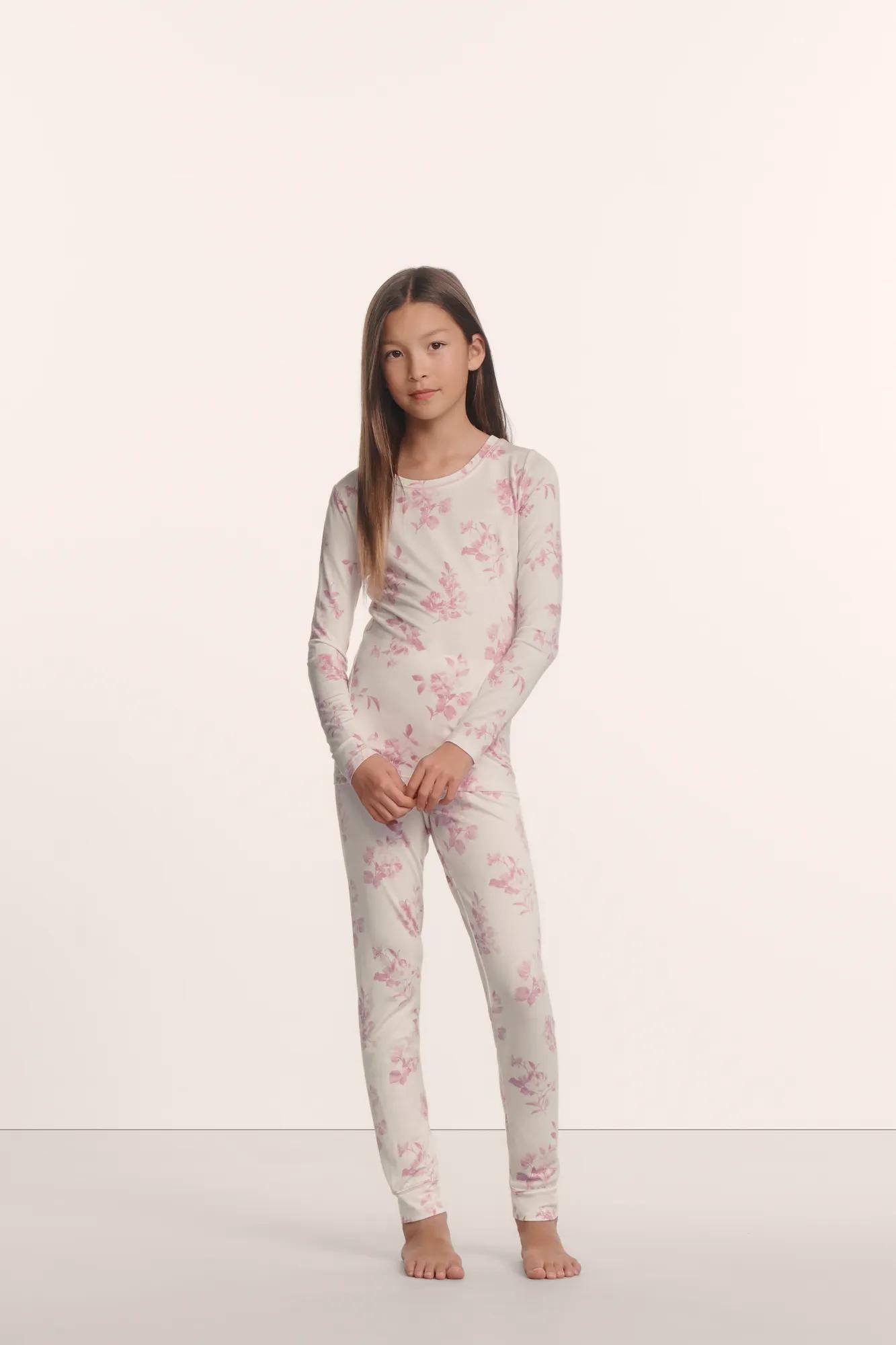 Model is wearing Kids Printed TENCEL™ Modal Unisex Long PJ Set in Rose Garden Cameo Pink/Pale Pi