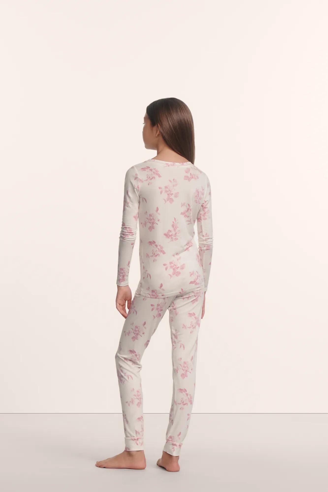 Model is wearing Kids Printed TENCEL™ Modal Unisex Long PJ Set in Rose Garden Cameo Pink/Pale Pi