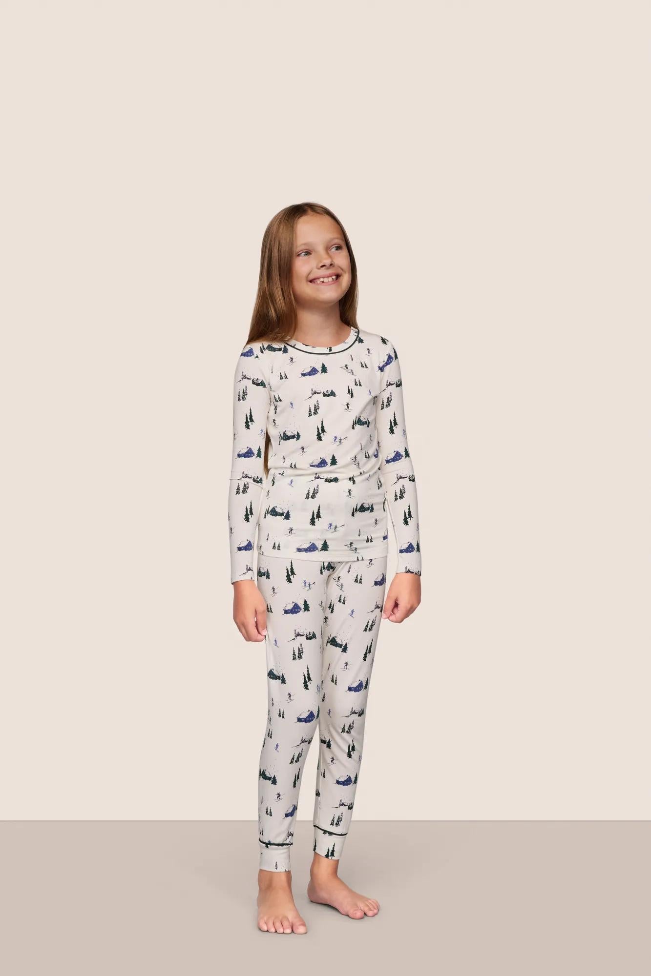 Model is wearing Kids Printed TENCEL™ Modal Unisex Long PJ Set  in Ski Chalet Ivory/Pine