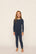 Model is wearing Kids Printed TENCEL™ Modal Unisex Long PJ Set in Santa Paws Navy/Ivory