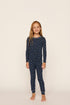 Model is wearing Kids Printed TENCEL™ Modal Unisex Long PJ Set in Santa Paws Navy/Ivory