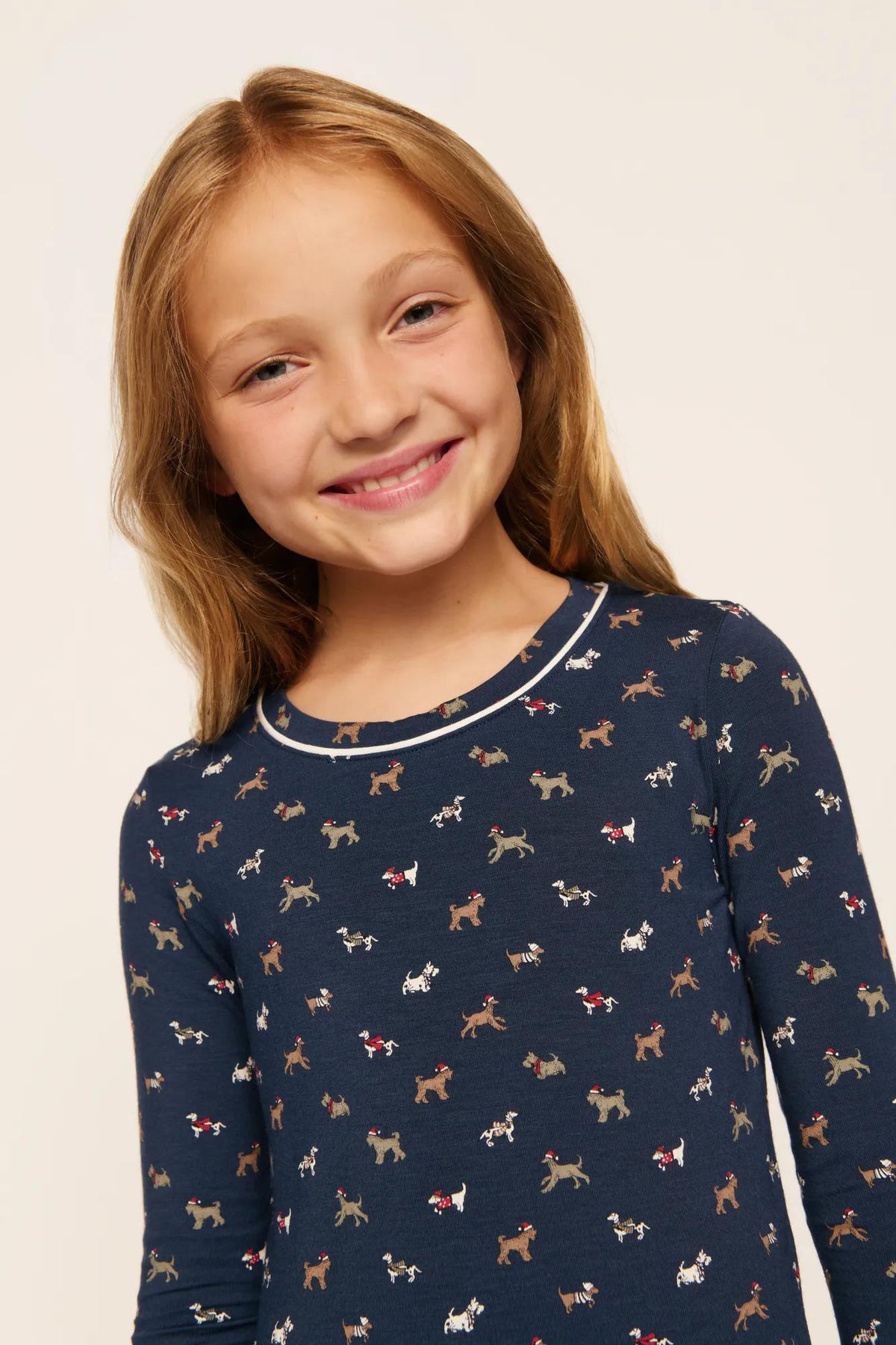 Model is wearing Kids Printed TENCEL™ Modal Unisex Long PJ Set in Santa Paws Navy/Ivory