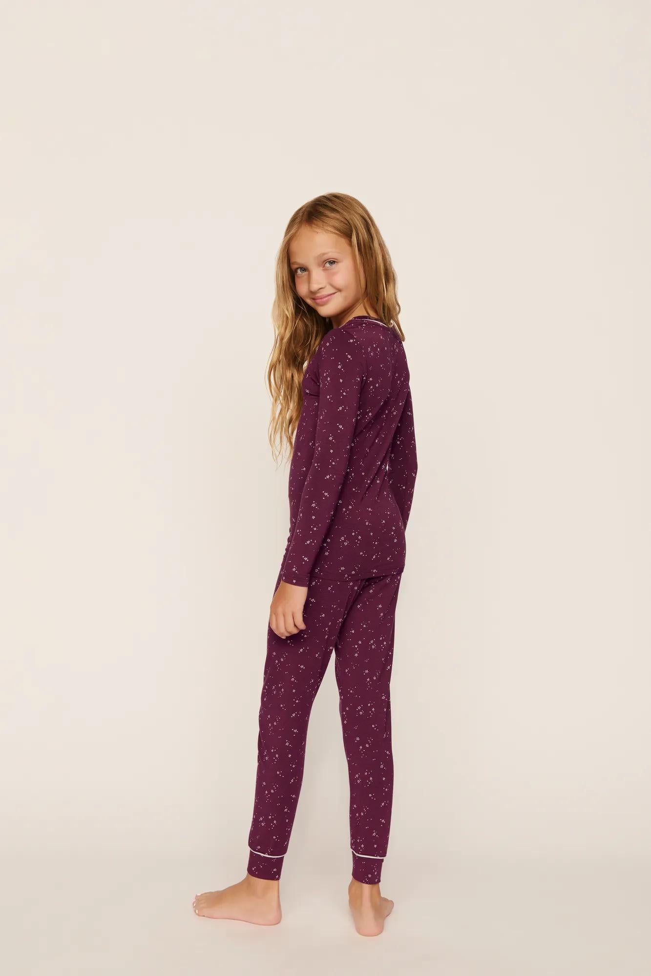 Model is wearing Kids Printed TENCEL™ Modal Unisex Long PJ Set in Starlight Wildberry/Ivory