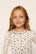 Model is wearing Kids Printed TENCEL™ Modal Unisex Long PJ Set in Twinkling Menorah Ivory/Navy