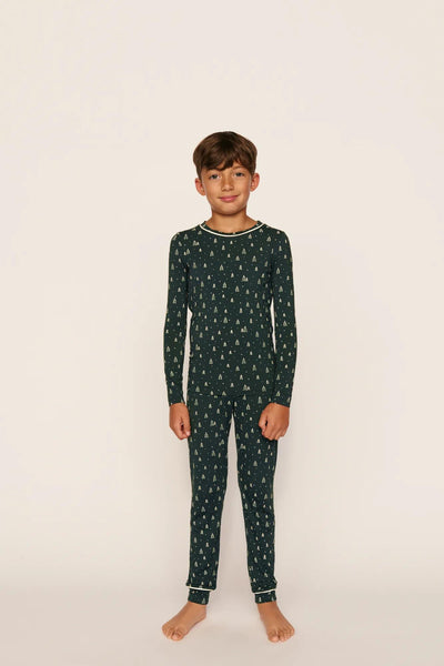 Model is wearing Kids Printed TENCEL™ Modal Unisex Long PJ Set in Winter Pine/Ivory