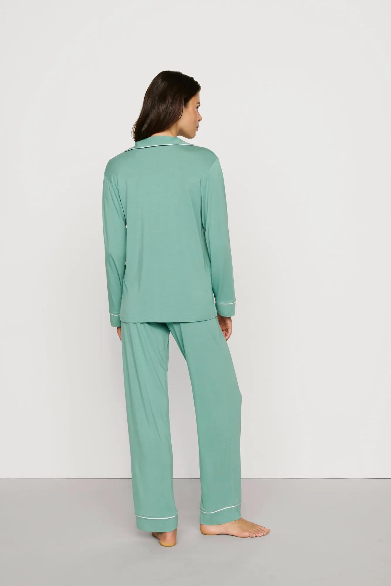 Model is wearing Gisele TENCEL™ Modal Long PJ Set in Seagrass/White