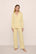 Model is wearing Gisele TENCEL™ Modal Long PJ Set in  Sunrise/Ivory