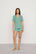 Model is wearing Gisele TENCEL™ Modal Relaxed Short PJ Set in Seagrass/White
