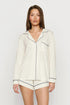Model is wearing Gisele TENCEL™ Modal Long Sleeve Short PJ Set in Ivory/Navy