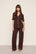 Model is wearing Gisele TENCEL™ Modal Short Sleeve & Pant PJ Set in Chocolate/Ivory