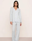 Model is wearing Gisele Printed TENCEL™ Modal Long PJ Set in Large Swans Ice Blue/Ivory