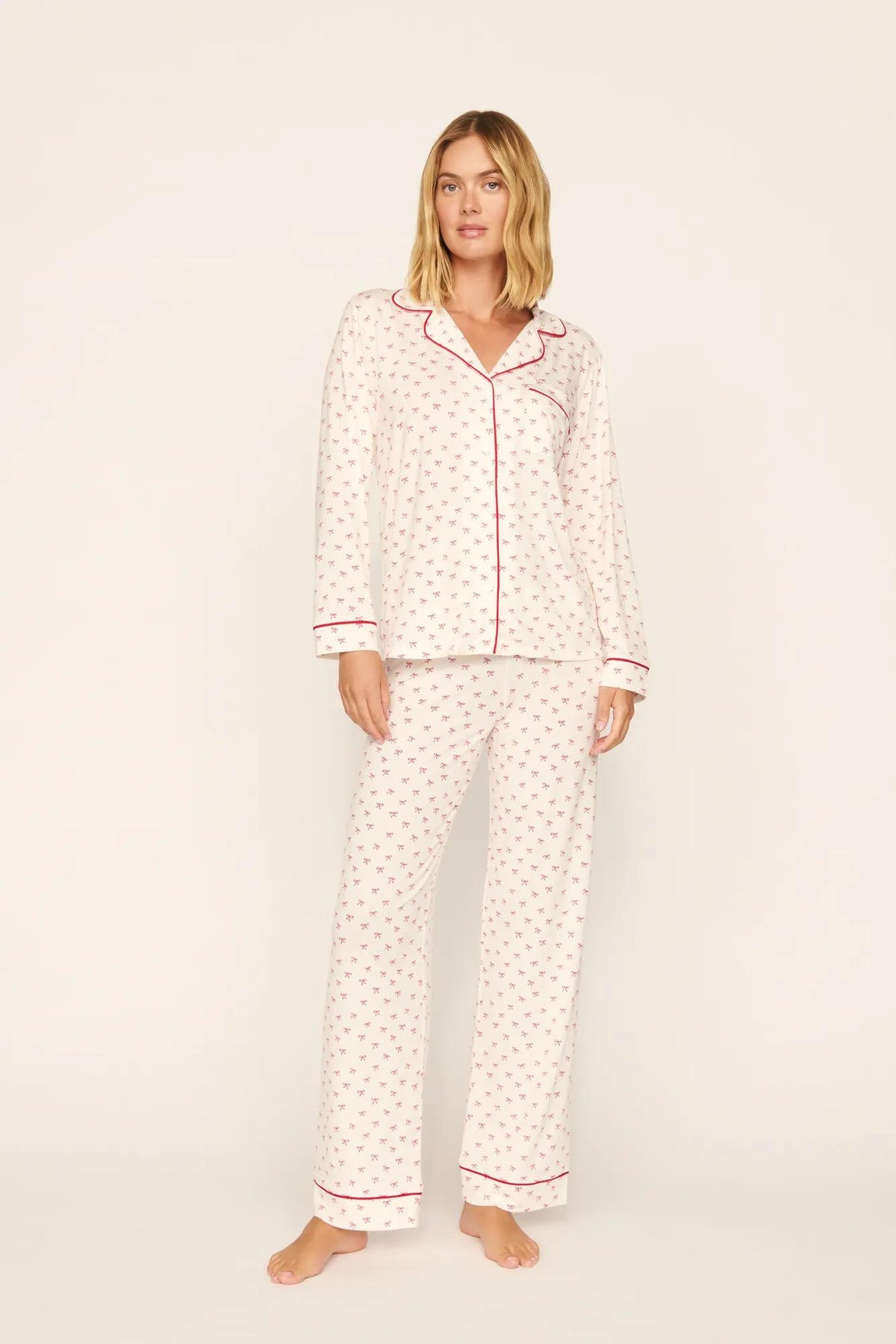 Model is wearing Gisele Printed TENCEL™ Modal Long PJ Set in Mini Bow Ivory/Holly Red