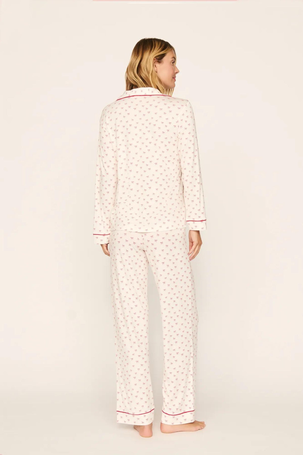 Model is wearing Gisele Printed TENCEL™ Modal Long PJ Set in Mini Bow Ivory/Holly Red
