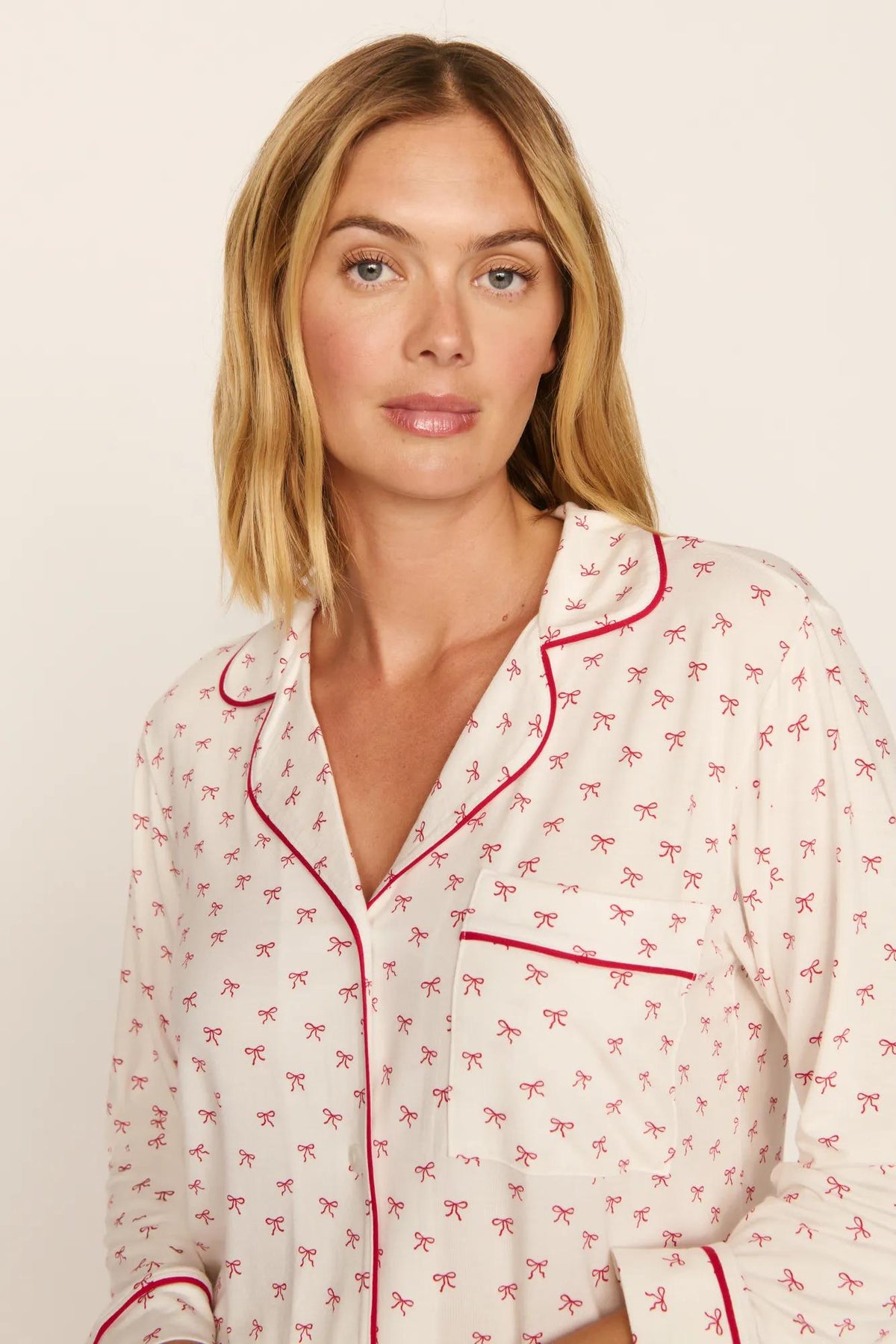 Model is wearing Gisele Printed TENCEL™ Modal Long PJ Set in Mini Bow Ivory/Holly Red