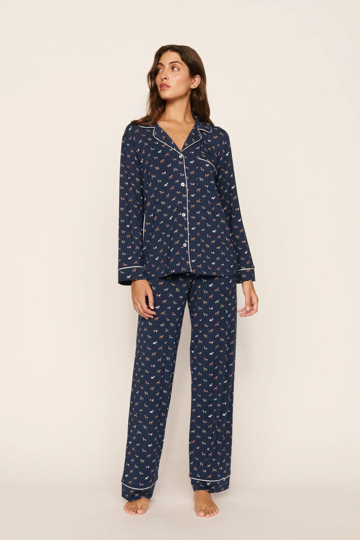 Model is wearing Gisele Printed TENCEL™ Modal Long PJ Set in Santa Paws Navy/Ivory