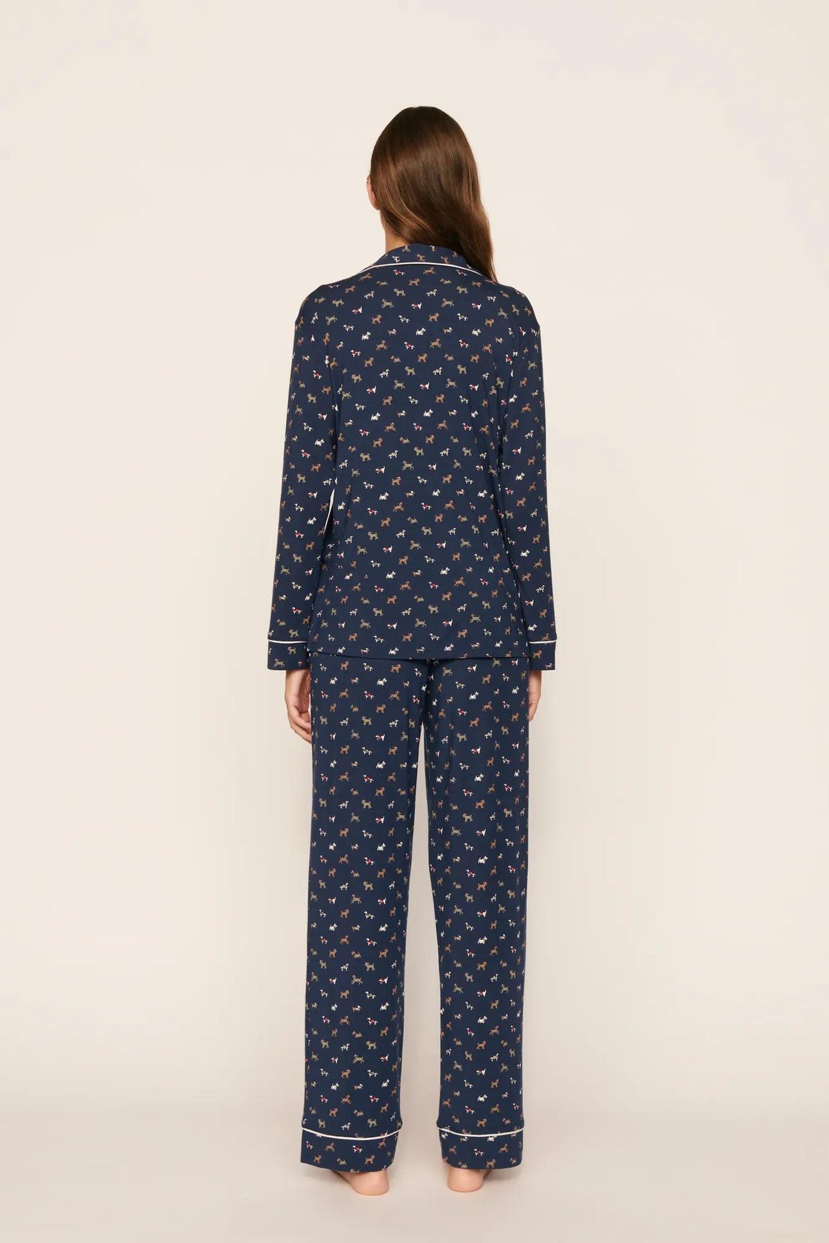 Model is wearing Gisele Printed TENCEL™ Modal Long PJ Set in Santa Paws Navy/Ivory