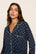Model is wearing Gisele Printed TENCEL™ Modal Long PJ Set in Santa Paws Navy/Ivory