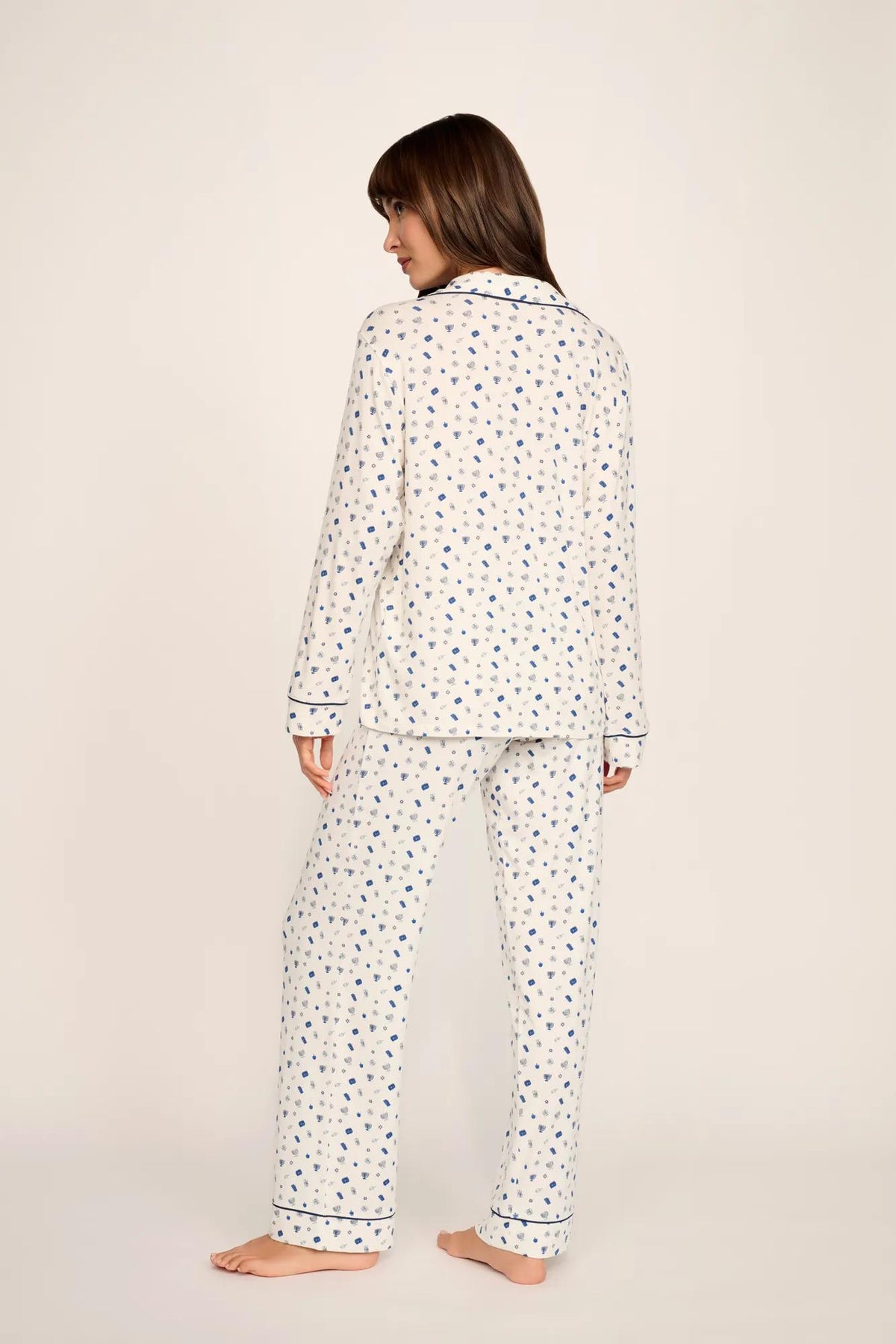 Model is wearing Gisele Printed TENCEL™ Modal Long PJ Set in Twinkling Menorah Ivory/Navy