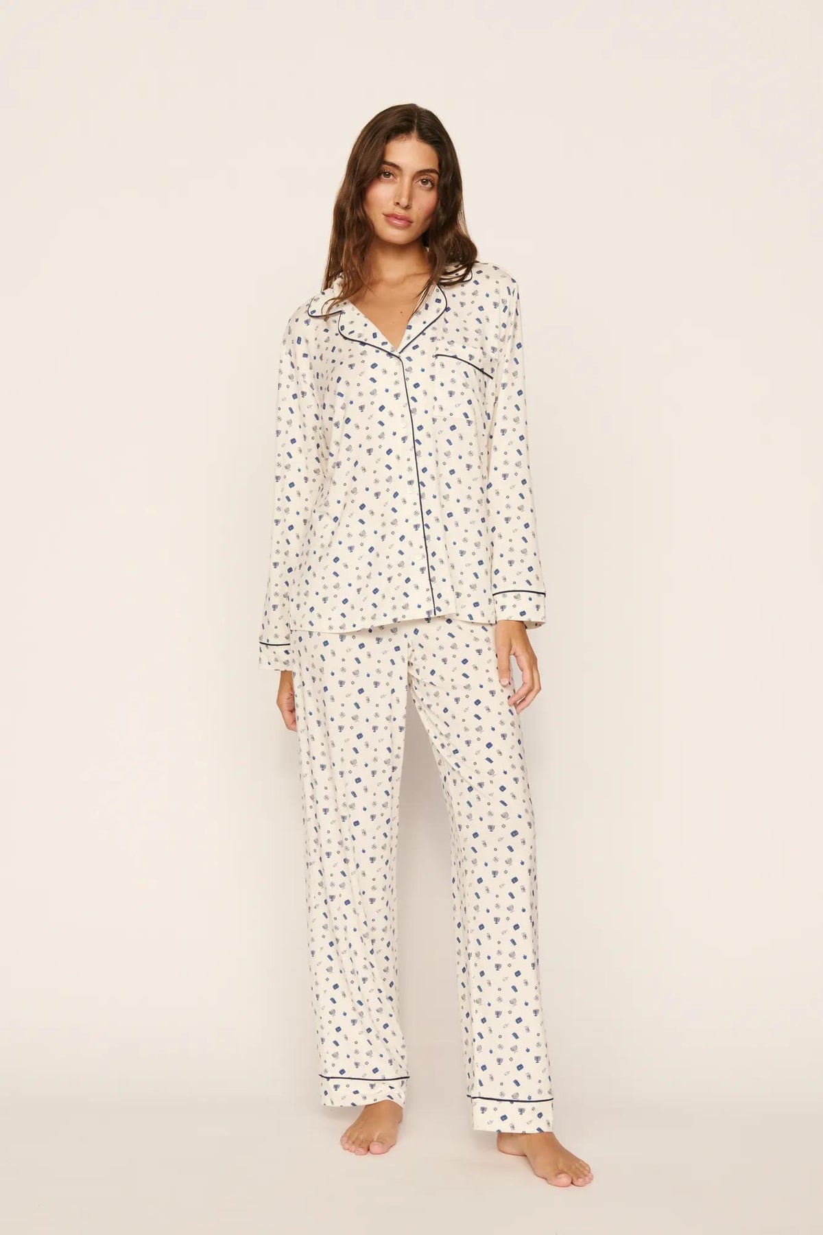 Model is wearing Gisele Printed TENCEL™ Modal Long PJ Set in Twinkling Menorah Ivory/Navy