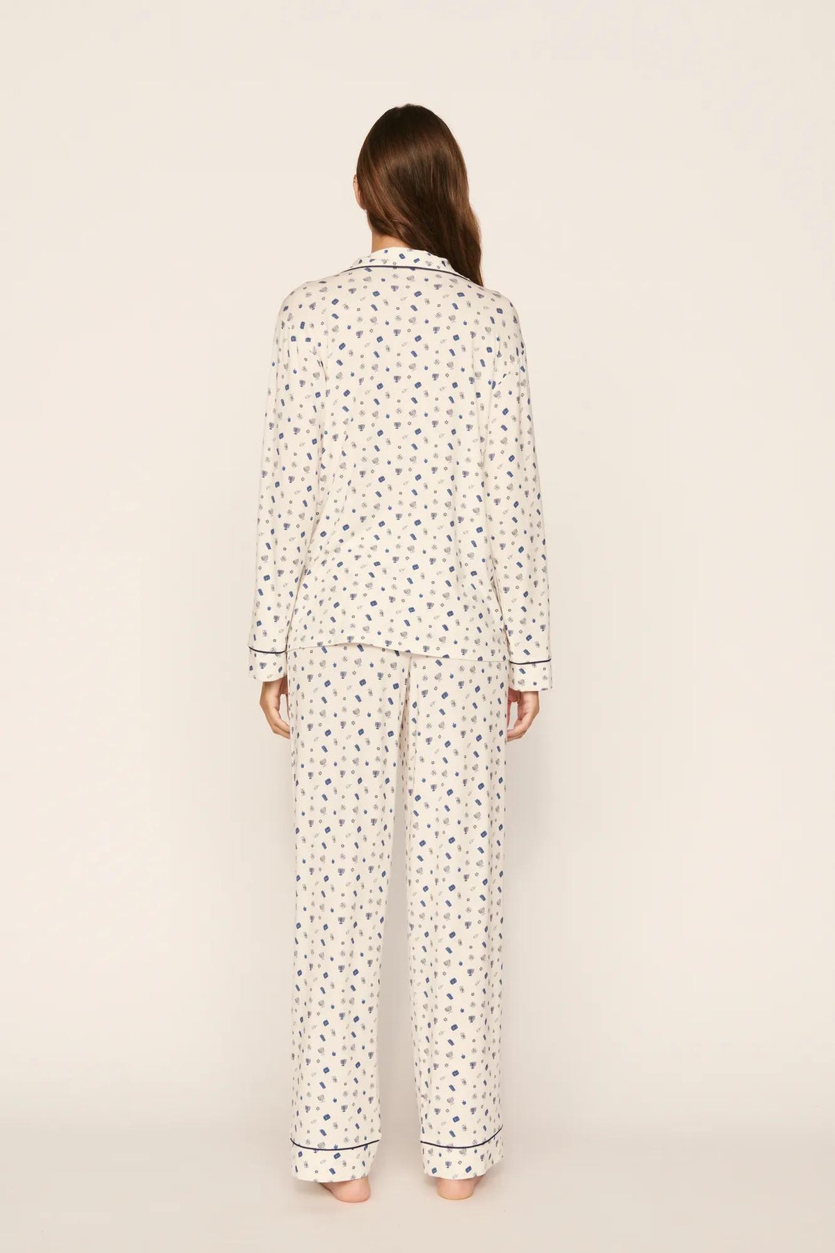 Model is wearing Gisele Printed TENCEL™ Modal Long PJ Set in Twinkling Menorah Ivory/Navy