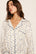 Model is wearing Gisele Printed TENCEL™ Modal Long PJ Set in Twinkling Menorah Ivory/Navy