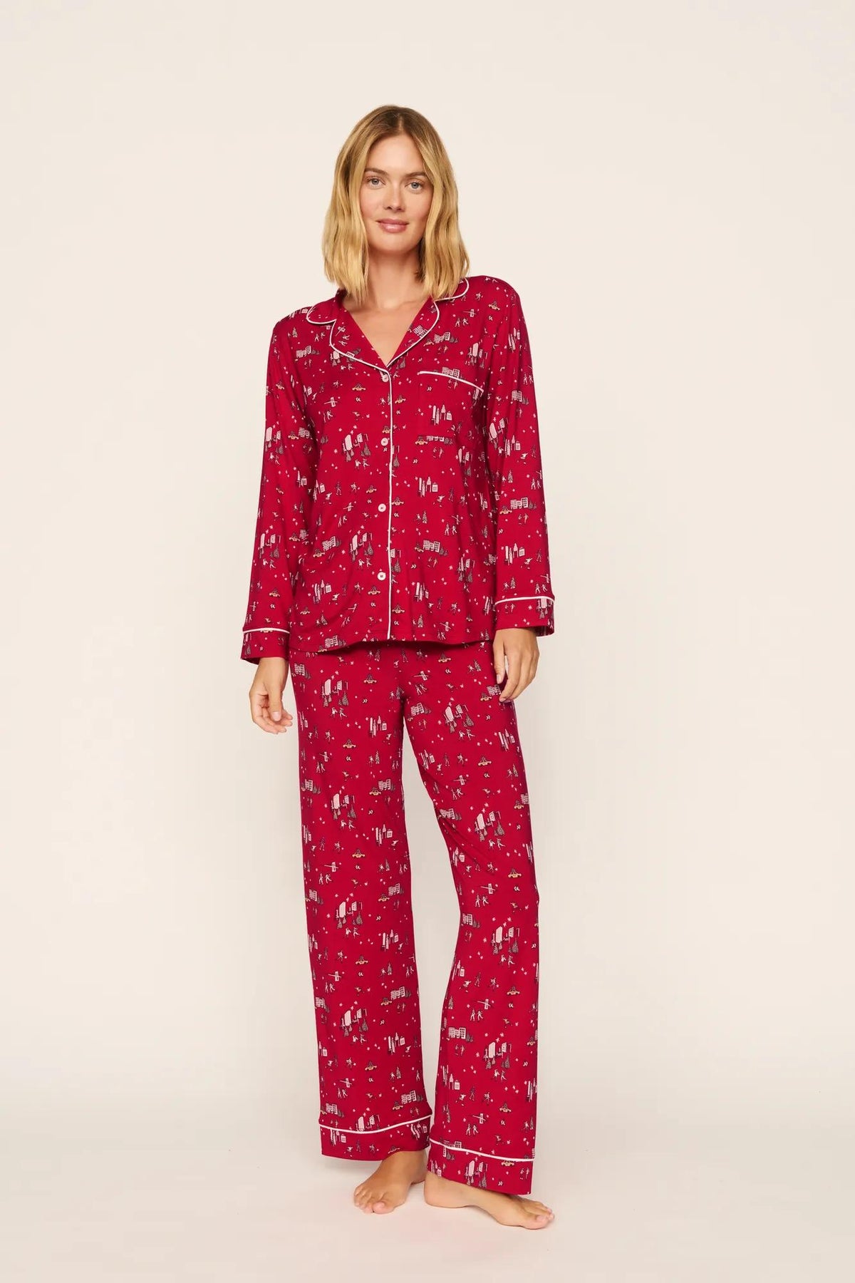 Model is wearing Gisele Printed TENCEL™ Modal Long PJ Set in Winter Skating Holly Red/Ivory