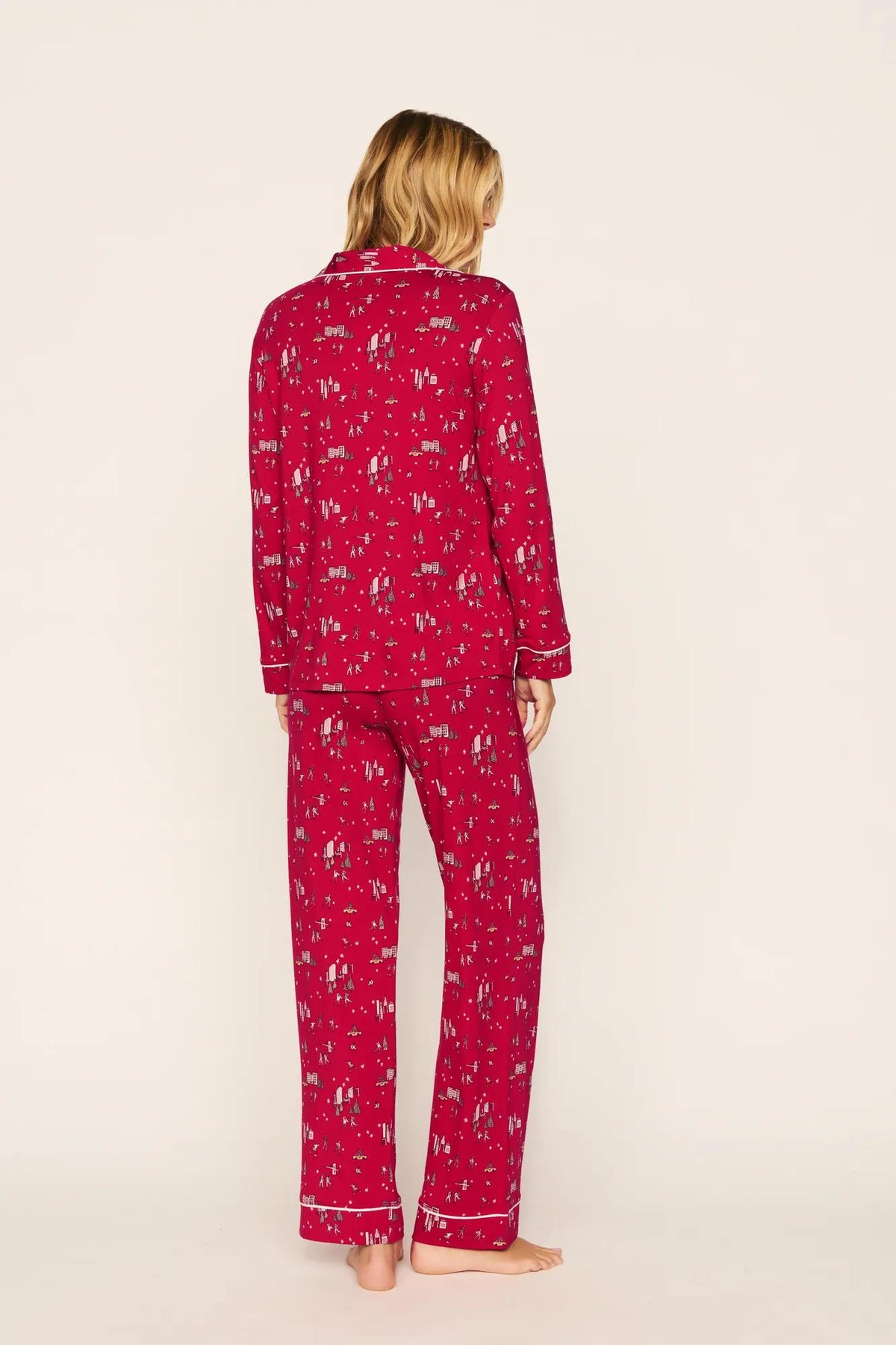 Model is wearing Gisele Printed TENCEL™ Modal Long PJ Set in Winter Skating Holly Red/Ivory
